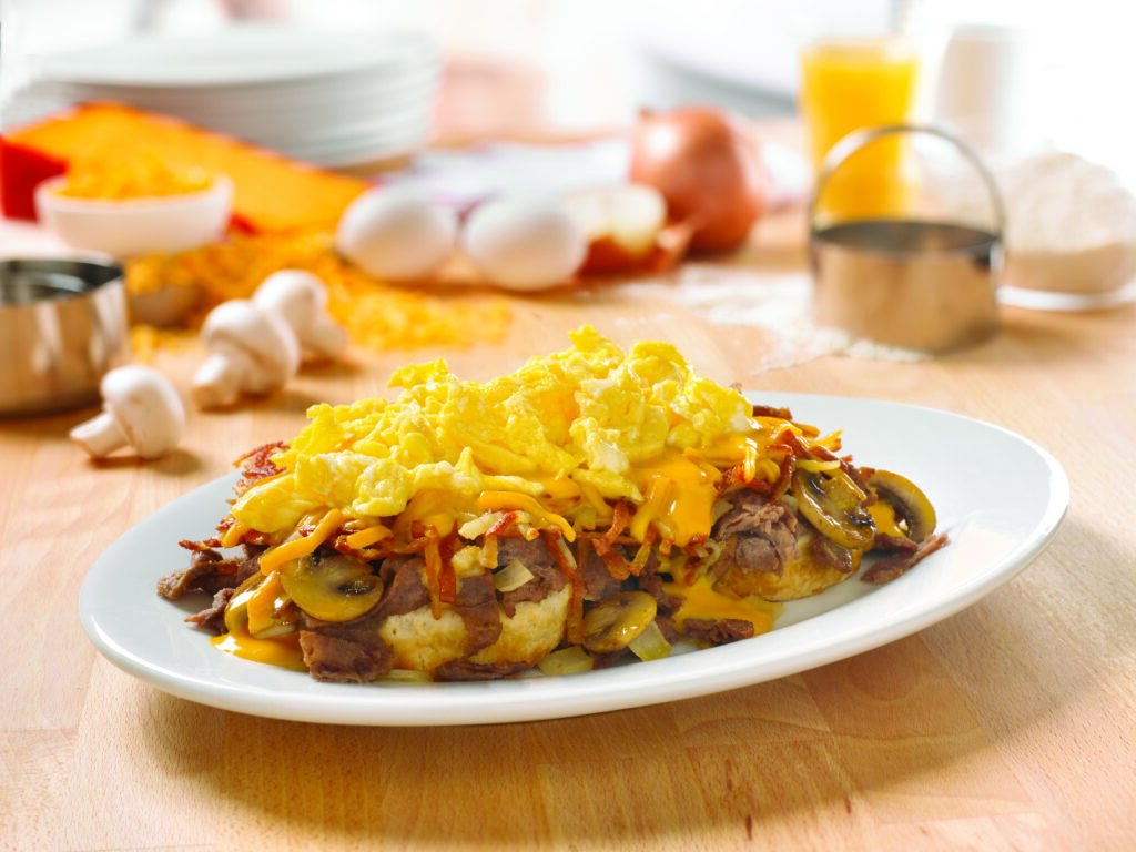 Huddle House Southern Smothered Steak and Eggs breakfast with scrambled eggs, cheese and mushrooms.